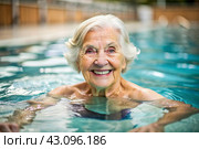 An elderly woman swims and does water aerobics in a heated pool, a happy and smiling retired woman. Recreational water sports. Стоковое AI-изображение, AI-художник Photojuli / Фотобанк Лори