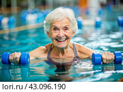 An elderly woman swims and does water aerobics in a heated pool, a happy and smiling retired woman. Recreational water sports. Стоковое AI-изображение, AI-художник Photojuli / Фотобанк Лори