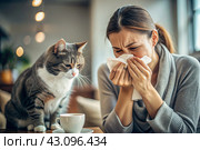 A woman sneezes into a white napkin at home. Allergies to cats and pet hair. There's a cat sitting next to me. Стоковое AI-изображение, AI-художник Photojuli / Фотобанк Лори