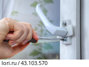 On double hung window, dismantle handle to supply restrictor that adjusts width of opening. Стоковое фото, фотограф Владимир Григорьев / Фотобанк Лори