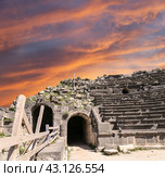 West Theatre of Umm Qais (Umm Qays)--is a town in northern Jordan near the site of the ancient town of Gadara, Jordan. Against the background of a beautiful sky with clouds (2016 год). Стоковое фото, фотограф Владимир Журавлев / Фотобанк Лори
