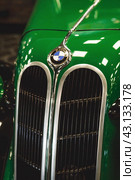 RUSSIA, MOSCOW - May 11, 2024: Close-up of the BMW logo on the hood of a retro car. Редакционное фото, фотограф Photojuli / Фотобанк Лори