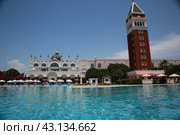 Beautiful hotel with tall tower from red bricks designed by Italian Venis style early morning (2018 год). Редакционное фото, фотограф Константин Сергеевич Синявин / Фотобанк Лори