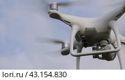 Krasnodar, Russia - June 11, 2017: Drone DJI Phantom 4 in flight. Quadrocopter against the blue sky with white clouds. The flight of the copter in the sky. Редакционное видео, видеограф Леонид Еремейчук / Фотобанк Лори