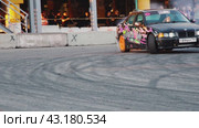 Severe sideways skidding of the car when turning on asphalt. Performances of drift masters at an amateur festival at the Mega Belaya Dacha site. Russia. Moscow. 19.05.2024. Редакционное видео, видеограф Ярославский Максим / Фотобанк Лори