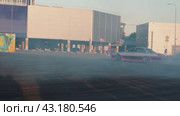 An amateur drift car smoothly makes an eight in front of visitors at the Mega Belaya Dacha site. Russia. Moscow. 19.05.2024. Редакционное видео, видеограф Ярославский Максим / Фотобанк Лори