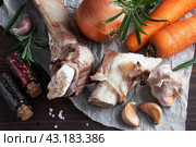 Beef bone and vegetable ingredients for cooking broth. Healthy food with collagen and amino acids. Copy space. Стоковое фото, фотограф Глущенко Елена / Фотобанк Лори