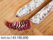 Spanish sausage fuet on a wooden table, closeup. Стоковое фото, фотограф Яков Филимонов / Фотобанк Лори