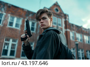 Schoolboy walking with a gun on the background of the school, school shootings concept, school violence. Стоковое AI-изображение, AI-художник Anastacia Gaikova / Фотобанк Лори