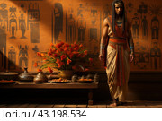 A man in traditional ancient Egyptian clothing standing against the background of a wall with hieroglyphs. His clothes are decorated with complex patterns and golden elements. He wears armlets and a headdress that emphasize his status. Next to it is a table with various dishes and decorations. Стоковое AI-изображение, AI-художник Анна Кривицкая / Фотобанк Лори