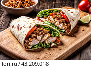 Fresh chicken shawarma wrap on wooden board. Savory chicken shawarma with vegetables and herbs on a rustic wooden serving platter. Food service concept. Copy ad text space. Generate Ai. Стоковое AI-изображение, AI-художник Aleksandr Golubev / Фотобанк Лори