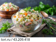 Traditional Russian Olivier salad for a feast on a plate on a wooden countertop. generative AI. Стоковое AI-изображение, AI-художник Photojuli / Фотобанк Лори