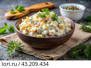 Traditional Russian Olivier salad for a feast on a plate on a wooden countertop. generative AI. Стоковое AI-изображение, AI-художник Photojuli / Фотобанк Лори