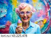 Portrait of an extraordinary, stylish, fashionable elderly woman, a pensioner of 70 years old, with glasses and ice cream in her hand. The concept of happy seniors and delicious desserts. Стоковое AI-изображение, AI-художник Photojuli / Фотобанк Лори
