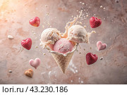 Sweet dessert. The love of ice cream. A heart-shaped ice cream cone with splash, hearts and splashes. The concept of Valentine's Day. Banner, advertisement. Стоковое AI-изображение, AI-художник Photojuli / Фотобанк Лори