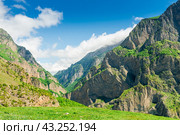 Steep vertical green rocks of the Karmadon gorge in the mountains of the northern Caucasus. Russia. Стоковое фото, фотограф Константин Лабунский / Фотобанк Лори