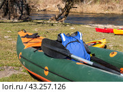 Kayak on the river bank. Active pastime of the weekend. Sports tourism. Kayak rafting in the spring. Kayak green inflatable. Стоковое фото, фотограф Zima Nadezhda / Фотобанк Лори
