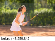 A woman in a white dress is playing tennis on a court. Стоковое фото, фотограф Константин Шишкин / Фотобанк Лори