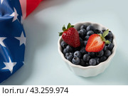 Blueberry decorated American flags for Independence Day on blue background. Стоковое фото, фотограф Светлана Лажко / Фотобанк Лори