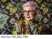 Portrait of a stylish, fashionable elderly woman, a pensioner of 70 years old, wearing glasses and clothes with floral prints. The concept of the elderly. Стоковое AI-изображение, AI-художник Photojuli / Фотобанк Лори