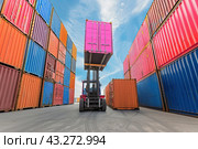 A large loader performs loading and unloading operations at the container site during the import and export of goods. The concept of international cargo delivery. Стоковое AI-изображение, AI-художник Ярославский Максим / Фотобанк Лори
