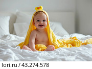 Adorable Baby Boy Lying Under Yellow Hooded Towel after Bath. Cute little Toddler Playing after Bathing in Bed. Blond Hair Child Fooling, Grimacing, Making Face. Close Up. Kid Smiling happily, daytime. Стоковое AI-изображение, AI-художник Марина Демидюк / Фотобанк Лори