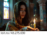 Молодая женщина ставит свечи в церкви. Стоковое AI-изображение, AI-художник Щеголева Ольга / Фотобанк Лори