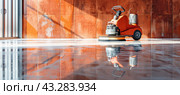 A wheel is currently employed by the machine in order to buff the shiny marble surface. Стоковое AI-изображение, AI-художник Юрий Поздников / Фотобанк Лори