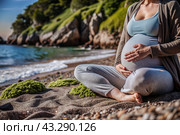 Relaxation, peace of mind, sea air. Close-up of the tummy. A pregnant woman on the beach by the sea. The concept of pregnancy, childbirth and parental responsibilities. Стоковое AI-изображение, AI-художник Photojuli / Фотобанк Лори