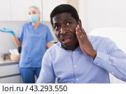 Dissatisfied male patient after cosmetic procedures in aesthetic clinic. Стоковое фото, фотограф Яков Филимонов / Фотобанк Лори