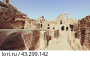 Ruins of ancient Berber fortified Ksar Beni Barka located in Tataouine Governorate in southern Tunisia with stone remains of dwelling and storing rooms. Стоковое видео, видеограф Яков Филимонов / Фотобанк Лори