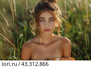 Young girl in boho style posing against a background of green nature. She is wearing a light, off-the-shoulder blouse with a floral pattern. Her hair is gathered in a careless bun, with strands released, giving the image a romantic and natural look. The girl's face is decorated with light makeup, emphasizing her blue eyes and delicate features. The background of the photo consists of blurred greenery, which adds freshness and natural harmony to the photo. Стоковое AI-изображение, AI-художник Анна Кривицкая / Фотобанк Лори