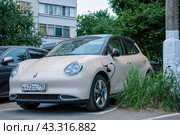 Electric car GWM ORA 03 parked on street and charging (2024 год). Редакционное фото, фотограф Константин Григорьев / Фотобанк Лори