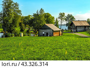 Landscape on the island of Kizhi with the buildings of the mill and a residential building (2023 год). Редакционное фото, фотограф Владимир Ушаров / Фотобанк Лори