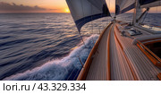 The yacht is sailing at full sail towards sunset. View from the port side. Стоковое AI-изображение, AI-художник Ярославский Максим / Фотобанк Лори