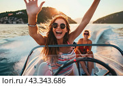 A happy girl drives a boat on the lake. Copy space. Стоковое AI-изображение, AI-художник Ярославский Максим / Фотобанк Лори