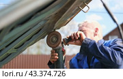 Car body shop. Repair man processes the welding seam using an angle grinder on replaced car part. Professional Body master grind old paint and rust. Rusty damage. Rusting car. Hands with tool close-up. Стоковое видео, видеограф Марина Демидюк / Фотобанк Лори