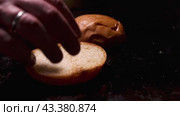 A talented chef creates delicious burger buns by hand on a sizzling hot griddle. Стоковое видео, видеограф Victor Kaprov / Фотобанк Лори