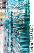 Stacks of finished glass in a glass factory. Стоковое AI-изображение, AI-художник Юрий Поздников / Фотобанк Лори