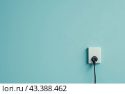 White plastic power outlet. Power socket. Brand new electrical socket isolated on a blue wall with black single plug switched on. Renovated studio apartment power supply background. Empty copy space. Стоковое AI-изображение, AI-художник Марина Демидюк / Фотобанк Лори