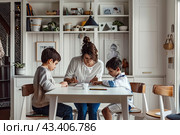 Mom and children do their homework in a bright room. Стоковое AI-изображение, AI-художник Ярославский Максим / Фотобанк Лори