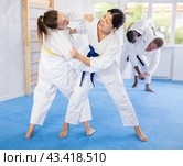 Girl tapping woman out with jiu jitsu grappling submission in gym. Стоковое фото, фотограф Яков Филимонов / Фотобанк Лори