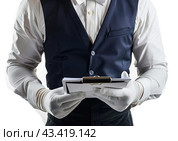 A young unidentified waiter takes an order on a white background. Isolated. Стоковое AI-изображение, AI-художник Ярославский Максим / Фотобанк Лори