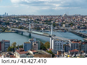 ISTANBUL, TURKEY - OCTOBER 12 ,2021: Panoramic view of Istanbul Bosphorus on sunset. Istanbul Ataturk Bridge and Halic Bridge. cloudy blue sky. Редакционное фото, фотограф Павел Муравьев / Фотобанк Лори