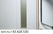 Foaming cracks in the door frame with mounting foam. Construction and repair. Installation and fastening of a wooden frame. Стоковое видео, видеограф Дмитрий Кобзев / Фотобанк Лори