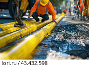 Construction work for replacement of engineering pipes. Workers installing an underground pipe on city street. Repair, laying water pipes or replacing sewer pipes Installation of plumbing, sanitation. Стоковое AI-изображение, AI-художник Марина Демидюк / Фотобанк Лори