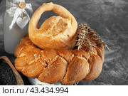 Assortment of white bread. Kalach and challah made of wheat flour on table with milk. Copy space. Стоковое фото, фотограф Оксана Медведева / Фотобанк Лори