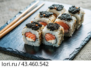 Japanese food. Sushi rolls California, Philadelphia with eel, red caviar and salmon. The concept of the sushi bar menu. Стоковое AI-изображение, AI-художник Photojuli / Фотобанк Лори