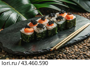 Japanese food. Sushi rolls California, Philadelphia with eel, red caviar and salmon. The concept of the sushi bar menu. Стоковое AI-изображение, AI-художник Photojuli / Фотобанк Лори