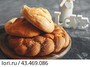 Assortment of white bread. Kalach and challah made of wheat flour on table with milk. Copy space. Стоковое фото, фотограф Оксана Медведева / Фотобанк Лори